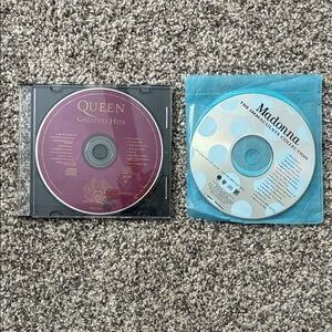 Queen Greatest Hits and Madonna The Immaculate Collection CDs